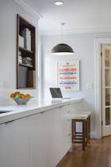 Fein also renovated the kitchen in a 1930s bungalow in Kansas City, Missouri. The countertop of a custom cabinet creates a breakfast nook at one end.