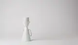 The glazed porcelain coffee set comes with a pot, a filter funnel, and three cups, which can be stacked together.