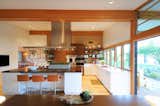 Throughout the house, Woolsey opened up confined rooms to create spacious areas where the family can live and play together. One example is shown here, where she expanded the kitchen by connecting it to a banquet breakfast area.