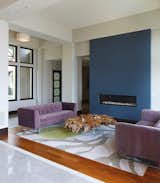 A closer look at the living space near the entrance reveals a modern fireplace that’s built into a blue accent wall.