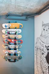 A custom board rack provides a space for the kids of the house to show off their prized decks.&nbsp;