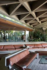 The famous living room is filled with custom leather-and-concrete sofas and geometric concrete ceilings.