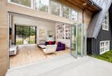 The second A-frame includes one end that’s made up entirely of glass. It houses a 60-foot great room that incorporates a kitchen, living room, and dining room.  Photo 16 of 21 in Living room by Nick Collison from Dwell Home Tours Lands in Silicon Valley