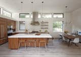 The combined kitchen/dining room is finished with walnut cabinets while the clerestory windows are continued in the same format as the rest of the house.  My Saves from Dwell Home Tours Lands in Silicon Valley