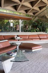In the living room—which has become known as the "Big Lebowski Room"—boasts a curvy concrete-and-leather sofa that resulted from a collaboration between Goldstein and Lautner. The ceiling is covered with sandblasted concrete that still has the original miniature circular skylights.