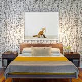 The husband-and-wife team behind Rethink Design Studio sent us this bedroom shot from a home they designed for a family of four. They covered the bedroom wall with a bold patterned wallpaper from Hygge &amp; West and finished it with artwork from the Animal Print Shop.