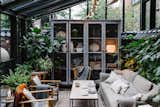 Shown here is the lounge seating vignette in the covered patio/garden area, which is filled with greenery and furniture that's covered with warm textiles.  Photo 13 of 16 in Loves. from A Visual Journey Through Stockholm's Hotel Ett Hem