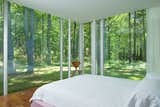 The master bedroom in the guest house is clean and simple, shown here with a Cherner Side Chair posted up in the corner.