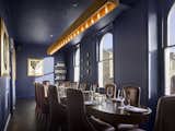Dining, Chair, Table, Shelves, Pendant, and Dark Hardwood On the top floor, you’ll find The Boardroom, a private dining room that holds its own private bar.  Dining Chair Dark Hardwood Table Shelves Photos from Gin Enthusiasts Will Be Flocking to This New London Hotel