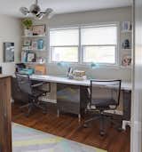 Carly uses one of the bedrooms upstairs as her office, which is furnished with Ikea desk tops that fit the extent of the wall.