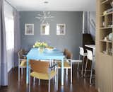 The dining room hosts a dining table that they found on Craig’s List, which Carly painted this bright blue in the basement of her old apartment.
