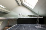 When you climb the spiral stairs, you’re led to the en-suite bathroom on the mezzanine level, which revels in natural light, thanks to a substantial angled skylight.  Photo 8 of 11 in Formerly Home to an Artist and Knitwear Designer, a Commercial Space-Turned-Dwelling Hits the Market
