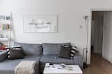 For the small yet open living space, Silvia included a sofa bed from Made.com, which can be easily pulled out for overnight guests. To the right of the sofa is the FLOS Toio Modern Floor Lamp by Achille and Pier Giacomo Castiglioni, while the artwork above the sofa is by Laura Jordan.
