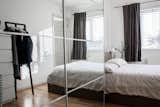 To create more storage and to make the bedroom feel larger, they placed an Ikea wardrobe with mirrored doors next to the bed. The clothing rack on the other side of the compact room is from HAY.