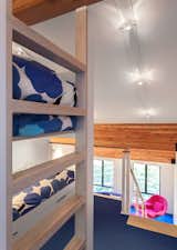 When the family visits the vacation home, the kids sleep in custom bunk beds in the open loft.&nbsp;