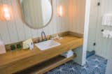 The bathrooms are filled with North Shore toiletries and custom ceramic floor tiles. Andrew Mau, who designed the shaka wallpaper in the restaurant, also created the Moana Vanity Mirrors.
