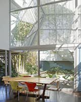 Table, Chair, Outdoor, and Back Yard  Photo 4 of 10 in A Perforated Screen Brings Privacy and Natural Light to This Bold Venice Home
