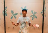 Michael Paulus spent a week painting hand-painted floral murals in the elevator cabs and restroom vestibule.