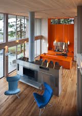 The kitchen and dining area is an open space which is filled with bright, warm  color, in this case an island and cabinets in orange Corian.

#orange #bright #color #kitchen #livingroom #diningroom #cabinetry #corian #hearth #highceilings #beachhouses #beachhouse #interstice #intersticearchitects #bradlaughton #bradlaughtonphotography #britishcolumbia #vancouverisland 