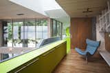 This strong color gesture of green traces the entry path from the guest house to the main house, providing cabinetry along the glass walk way. The door to the walkway, which is opened in this photo, slides closed to divide off the two volumes. 

#green #limegreen #bright #color #walkway #hallway #staircase #storage #beachhouse #beachouses #interstice #intersticearchitects #bradlaughton #bradlaughtonphotography #britishcolumbia #vancouverisland  Photo 1 of 36 in TreeHugger by INTERSTICE Architects