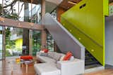 A sleek  staircase leads from the living room to a study. The bright green accent wall includes storage. 

#green #limegreen #bright #color #livingroom #entertainmentroom #staircase #storage #beachhouse #beachouses #interstice #intersticearchitects #bradlaughton #bradlaughtonphotography #britishcolumbia #vancouverisland