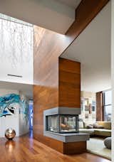 #BroadwayPenthouse #modern #midcentury #interior #inside #livingroom #seating #fireplace #pillows #wood #panels #rug #brick #shelves #mural #windows #lighting #NewYork #JoelSandersArchitects