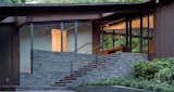 #BedfordResidence #1950s #modern #midcentury #exterior #outside #outdoors #landscape #green #structure #staircase #windows #deck #wood #panels #stone #interior #lighting #Bedford #BalmoriAssociates #JoelSandersArchitect  Photo 1 of 11 in Bedford Residence by Joel Sanders Architect