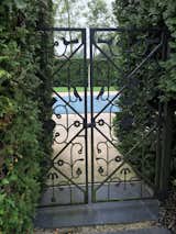 A close-up view of the custom iron gate by Alexander Girard, which opens to the Millers' pool. #alexandergirard #girard #millerhouse #midcentury #columbus #eames #saarinen #kiley #gate #iron