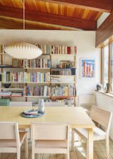 Michael Marriott bookshelves in an England home kitchen, paired with a Nelson bubble lamp and Artek table and chairs. Swoon.