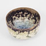 To create this speckled piece, Kingston, New York–based ceramicist Robert Kessler  works with zinc-based glazes that form crystals when cooled slowly after firing. Visual variations are made by adding amounts of cobalt, zinc, iron, silver, and tin oxides. 
