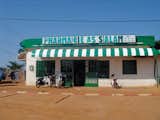 "Most houses are of the compound type. In poor areas, the countryside seems to invade the city, creating an in-between place of earth, mud, straw, wood, concrete and render." This commercial storefront was snapped in Niamey, Niger.