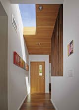 Striated wood paneling and new skylights give dimension to the renovated entryway.