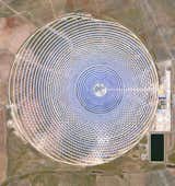Appearing like a giant oculus from above, the Gemasolar Thermosolar Plant in Seville, Spain, is a solar concentrator containing 2,650 heliostat mirrors that focus the sun's thermal energy to heat molten salt, which is then circulated to produce steam and electricity.  Reprinted with permission from Overview by Benjamin Grant, copyright (c) 2016. Published by Amphoto Books, a division of Penguin Random House, Inc.
Images (c) 2016 by DigitalGlobe, Inc.  Photo 10 of 15 in Ever Wondered About the View from Space? by Aileen Kwun