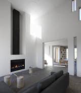 Soaring ceilings and a fireplace mark the home's main living area.  Photo 3 of 7 in A Minimalist Retreat at the Edge of South Africa's Karoo Desert