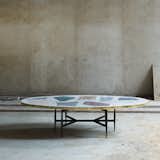 Magic Stone coffee table, steel legs and mosaic top with brass, by Rooms

The Magic Stone coffee table features a top inlaid with an oversize mosaic of colorful slabs balanced on slim steel legs. 
 