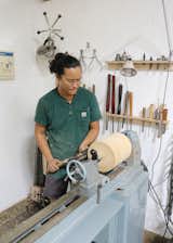 Designer Pat Kim creates wood vessels in his studio. 