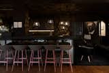 The bar at Libertine Lindenberg features a dark and moody color palette.