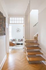 The residents now occupy two floors of the same West Village apartment where the previously lived below. A cantilevered staircase connects the two levels.

Photo by Howie Guja
Styling by Gorilla Styling