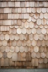 A mix of red cedar shingles and scales make of the exterior. The design is intended to be a "layered flow" that will age over time with the family, blending into the surrounding nature.