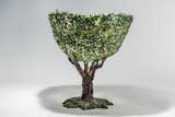 The tree vase is the result of a mosaic or decoupage technique in which pieces of resin were collaged on the surface to mimic foliage. "When you have new possibilities your ideas become more at reach," Pesce says.&nbsp;