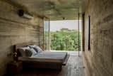 Bedroom, Bed, and Concrete Floor  Photo 1 of 7 in An Architect's Home and Studio Rises Above Rajagiriya