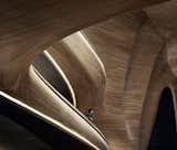 Set within a crystalline aluminum shell on a harsh tundra, the Grand Theater of China's Harbin Opera House (2009–2015) by MAD Architects provides an organic contrast to its exterior. Meant to evoke a block of naturally eroded wood, the space is lined in Manchurian ash, a move that enhances the acoustics of the space, while also supporting the local artisan community. 

Picture by Hufton + Crow
