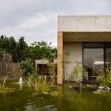 Located outside of Mexico City, Casa GP by architecture firm Ambrosi | Etchegaray integrates the local landscape with features like this pond.