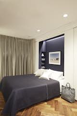 The Murphy bed niche is lined in deep blue fabric by KnollTextiles, one of the few pops of color in the space.&nbsp;