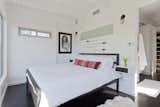 The couple's minimalist bedroom was imagined like a suite in a boutique hotel. There is a bedroom, closet, and bathroom, but minimal furniture as to avoid cluttering the bright white space. &nbsp;
