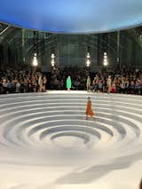 LONDON FASHION WEEK 2016: Anya Hindmarch's show, which took place  at The Royal Horticultural Halls, unfolded across an architectural stage. 

The structure began as a complete circle of rings that stepped down to a low point in the centre, before a section was slid back to reveal a tunnel. Models emerged from the gap between the steps, moving into different formations to show off the collection of muted neoprene coats and colourful leather bags.

"This season I've been preoccupied by the relationship between geometry and art," said the London-based designer. "These two visual mediums are both articulated through pattern, form and colour – things that have always fascinated me." #fashion

Photo by Debbie Bragg  Photo 11 of 16 in Primal & Cerebral by J. Scholti