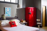 A red gym locker, repurposed as storage, is a whimsical touch in the bedroom.