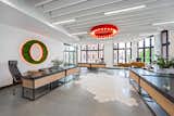 A planted wall-hanging in the shape of an eye dominates one of the desk areas.  Photo 2 of 8 in This Tech Office Is a Brilliant Mishmash of Styles