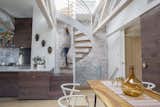 When Alan Ricks and Cristina de la Cierva moved into their Boston condo, a ship’s ladder was taking up space in the main living area. Following a lengthy renovation, a spiral staircase provides rooftop access.