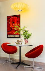Architectural designer Daniel Ian Smith revamped his garden apartment in Manhattan’s West Village after Superstorm Sandy hit in 2012. The original George Nelson lamp is an heirloom from his great aunt. The Soviet-era theater poster is from Poland.  Photo 2 of 5 in After Sandy, an NYC Designer Rehabs His Ruined Apartment—and Lends Neighbors a Hand with Theirs
